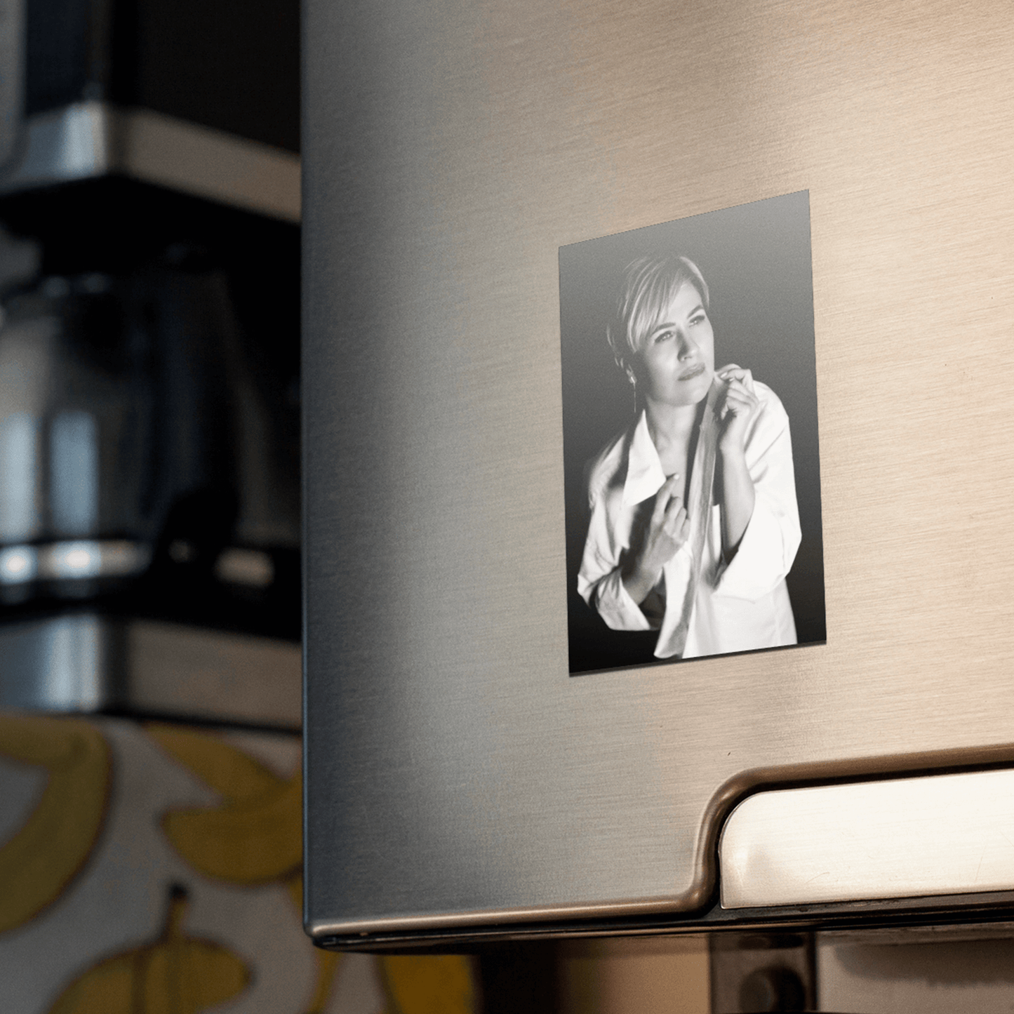 Custom photo magnet featuring a personal black and white picture on a fridge.