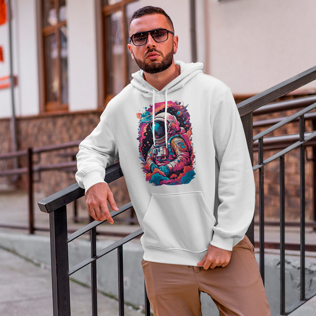 A stylish white hoodie featuring a colorful and detailed illustration of an astronaut surrounded by cosmic clouds and space elements. Ideal for space lovers and streetwear fans. Made by Your iDeas Shop.