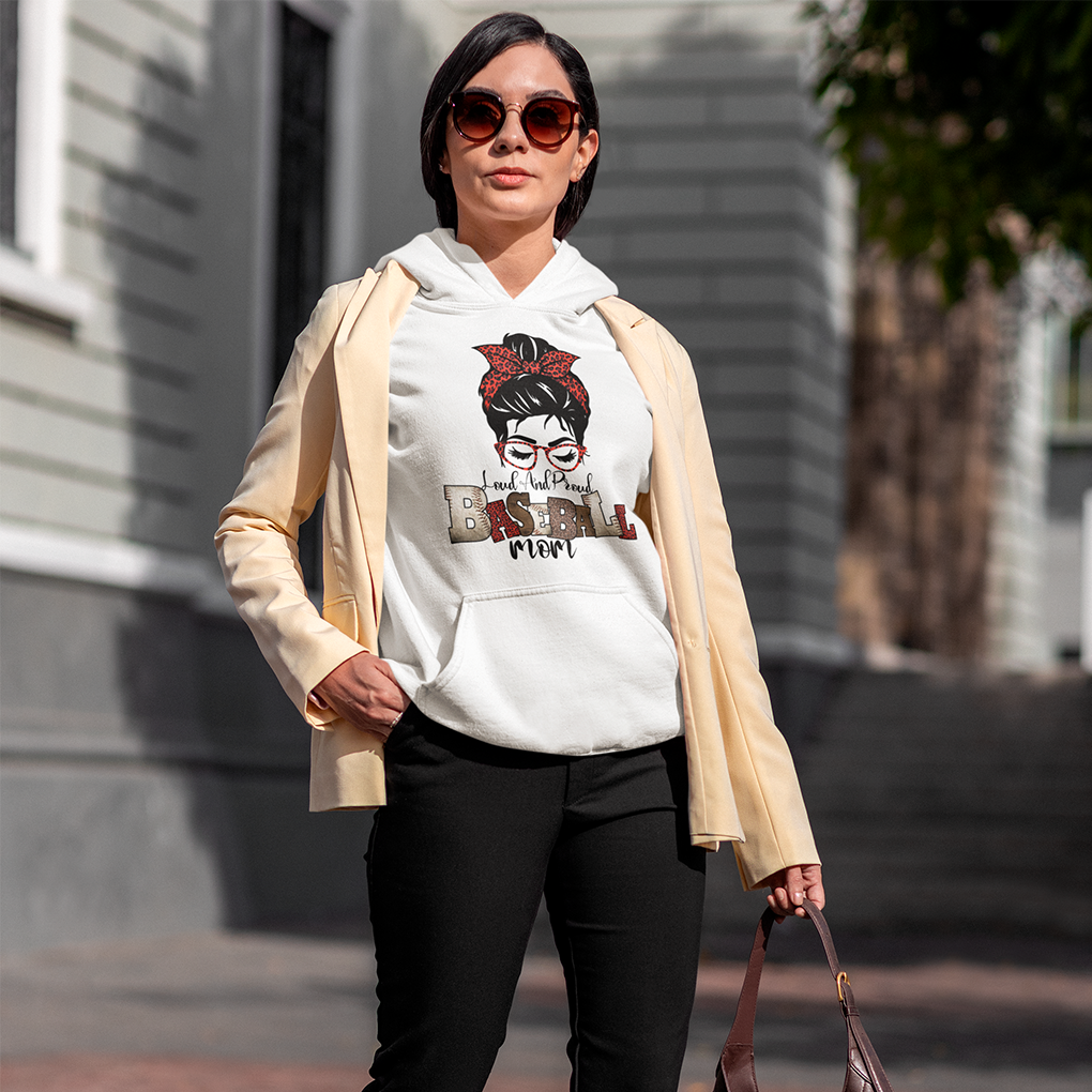 A white hoodie featuring the phrase "Loud and Proud Baseball Mom" with a stylish graphic of a woman with a red bow and sunglasses, designed in a trendy and empowering style. Perfect gift for sports moms. Made by Your iDeas Shop.