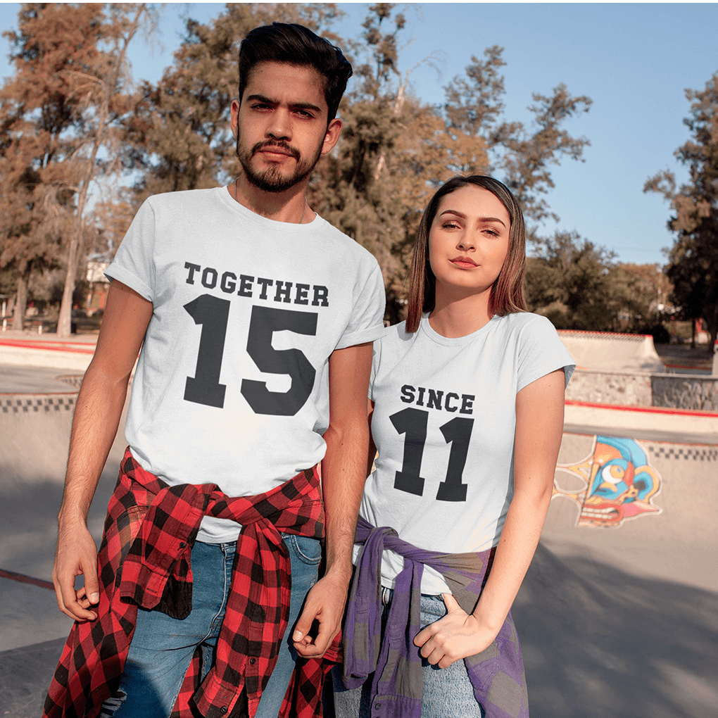 Two people wearing 'MR.' and 'MRS.' shirts with heart props against a colorful background.