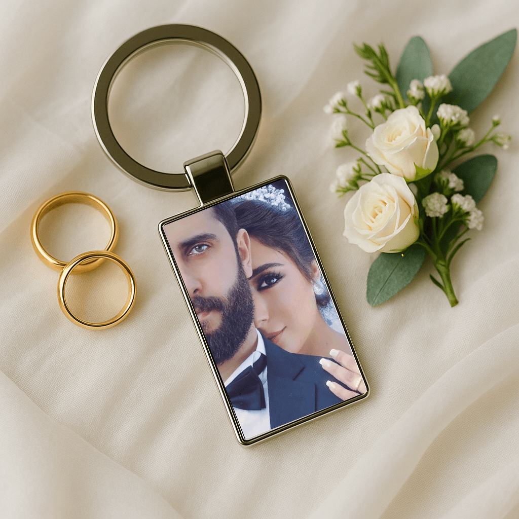 Custom keychain displaying a close-up wedding portrait beside gold rings and white roses, perfect for celebrating marriage. Made by Your iDeas Shop.
