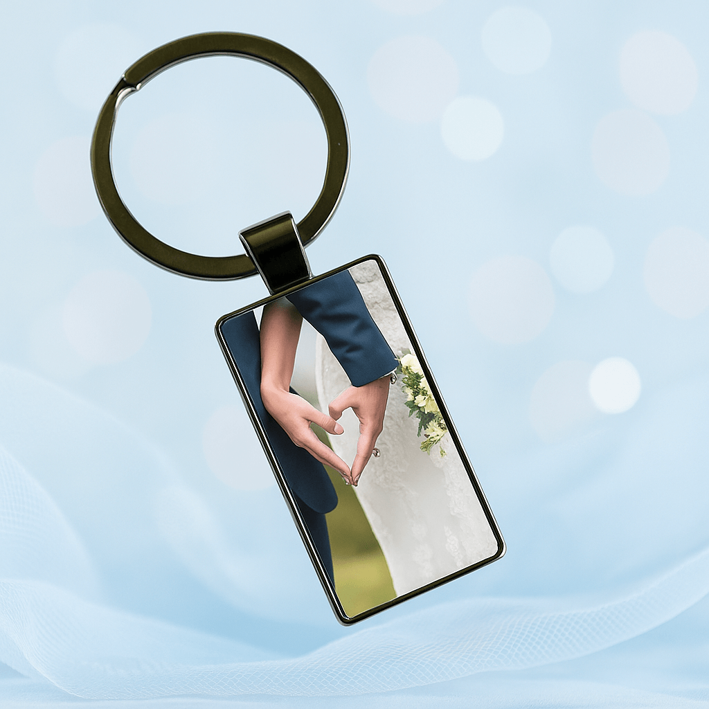 Custom keychain showing bride and groom forming a heart shape with their hands against a light blue background, symbolizing love and unity. Made by Your iDeas Shop.