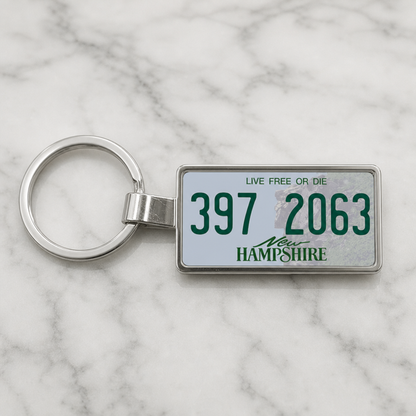 New Hampshire 397 2063 license plate keychain on_marble