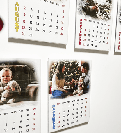 Personalized 12-month photo magnet calendar set displaying family memories for each month on a wall.