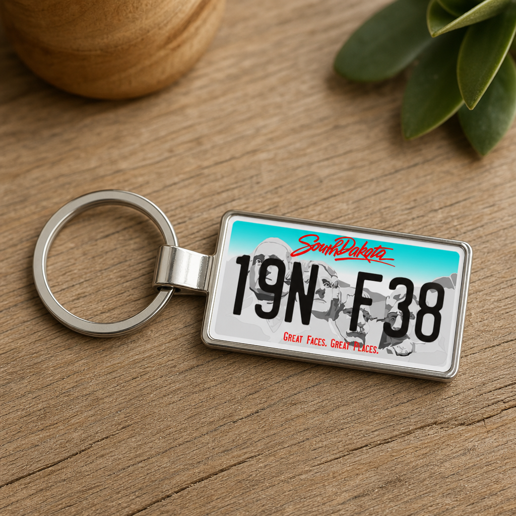 South Dakota license plate keychain on wood