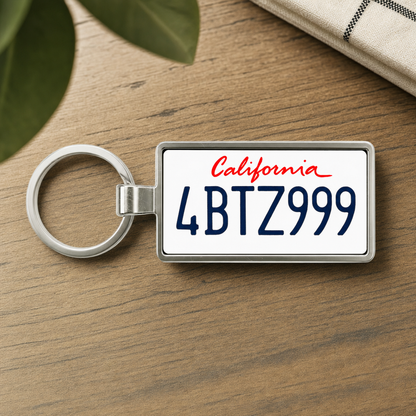 California 4BTZ999 license plate keychain on wooden table