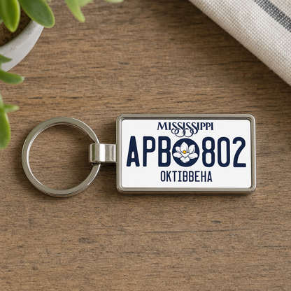 Mississippi APB 802 license plate keychain on_wood