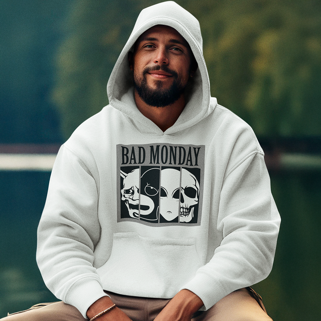 A white hoodie showcasing a bold black-and-white design with the text "BAD MONDAY" and a series of expressive mask illustrations including a demon, alien, and skull. Great for fans of alternative or street fashion. Made by Your iDeas Shop.