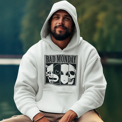A white hoodie showcasing a bold black-and-white design with the text "BAD MONDAY" and a series of expressive mask illustrations including a demon, alien, and skull. Great for fans of alternative or street fashion. Made by Your iDeas Shop.