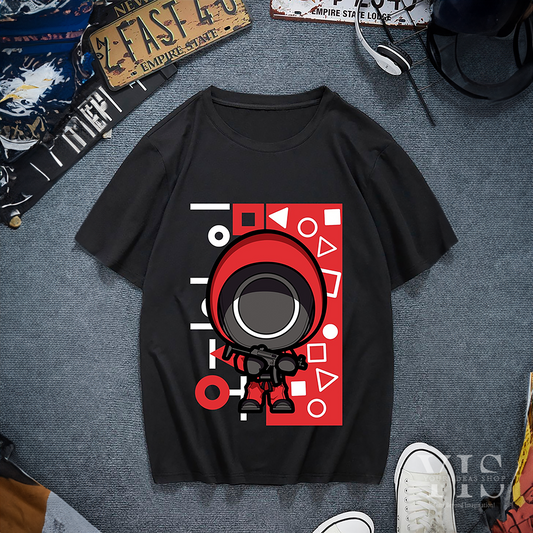 A black T-shirt featuring a chibi-style illustration of a red-suited guard with a large visor and weapon. The design includes a bold red background with geometric shapes and Korean text for added flair. A unique and playful addition to any wardrobe. Made by Your iDeas Shop