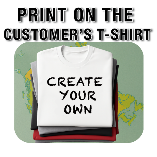 Stack of folded T-shirts with the top white shirt displaying the text 'CREATE YOUR OWN' in bold black letters, offering customers the option to print their personalized designs. Made by Your iDeas Shop.