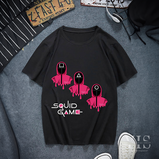 A black T-shirt showcasing a sleek design of three pink-suited guards with dripping effects. Each guard has a geometric mask: square, triangle, and circle. The 'Squid Game' logo is prominently displayed below the graphic. A bold and stylish choice for fans. Made by Your iDeas Shop.