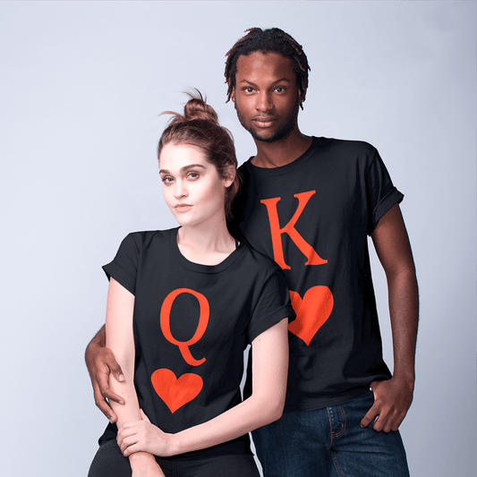 Stylish interracial couple in a studio setting wearing coordinating black shirts: hers displays a large red ‘Q’ above a heart symbol, his features a bold red ‘K’ and matching heart. A minimalist matching outfit for romantic partners and playing-card lovers. Made by Your iDeas Shop.