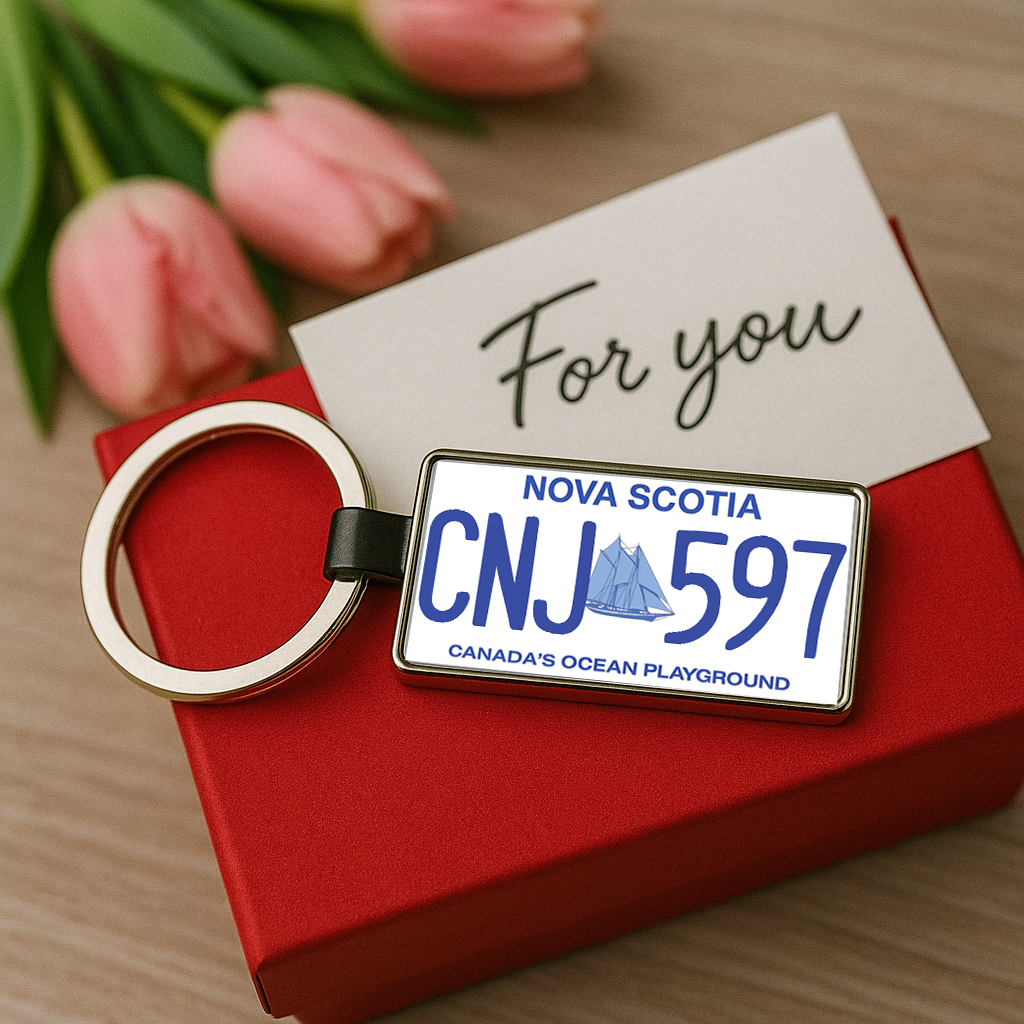 A Nova Scotia license plate keychain displaying CNJ 597, placed on a red gift box next to pink tulips and a 'For you' card, creating a romantic and personalized present scene. Made by Your iDeas Shop.