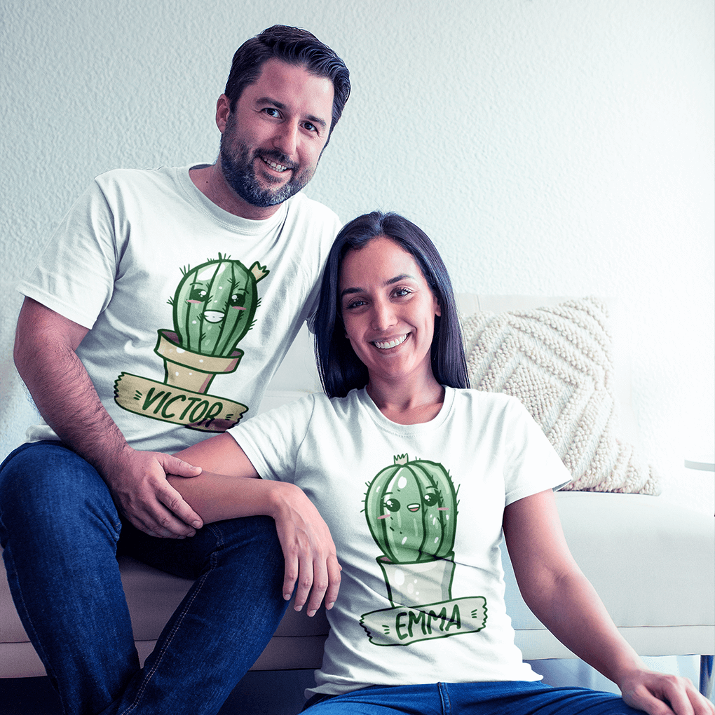 Man and woman sitting on a couch wearing white t-shirts with cactus designs and names.