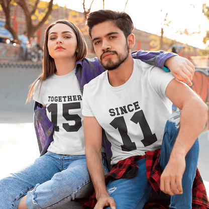 Man and woman with 'MRS.' shirt holding red roses against a purple background