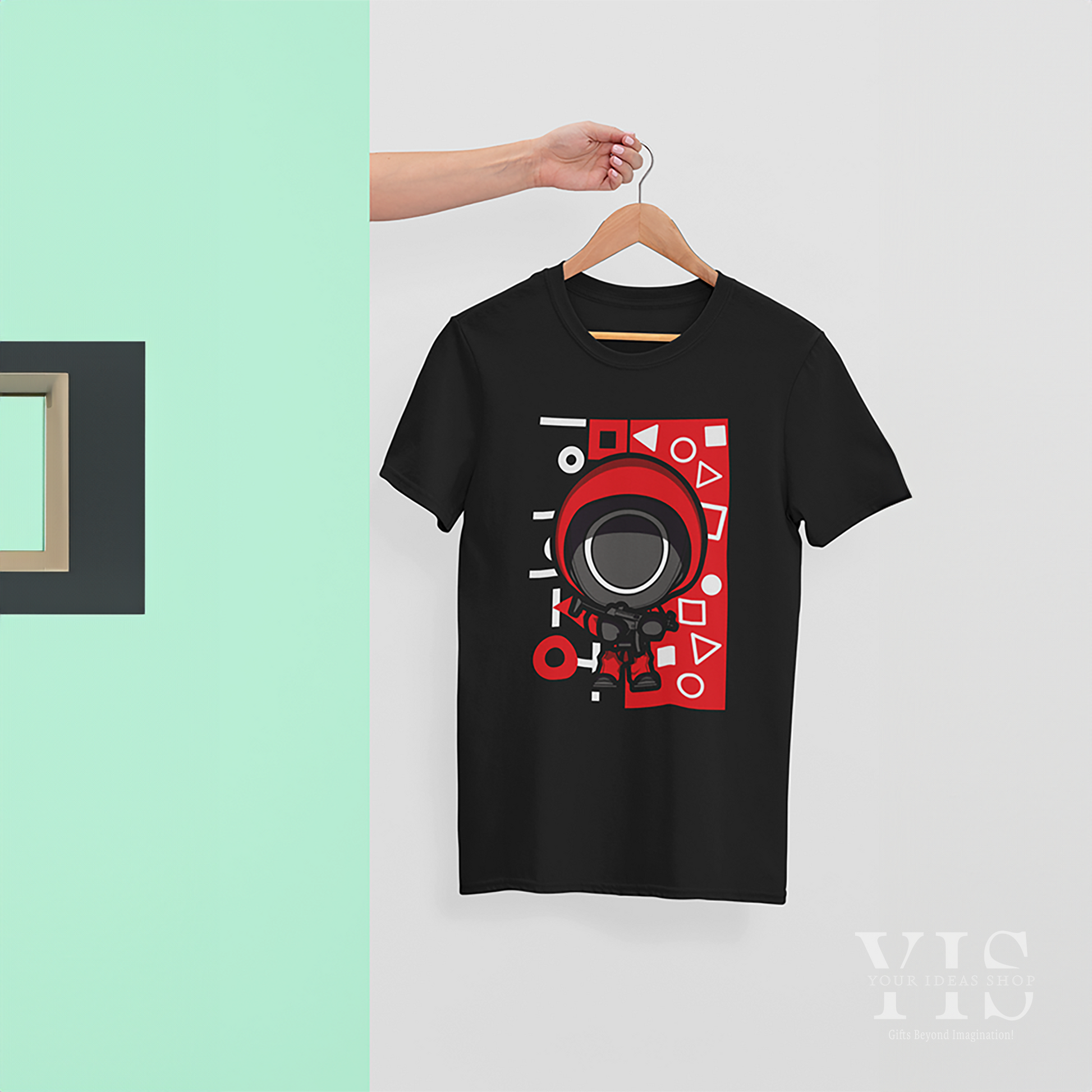 A black T-shirt featuring the Squid Game doll graphic worn by a young man in a lively urban street setting. Highlights the trendy appeal of the design. Made by Your iDeas Shop.