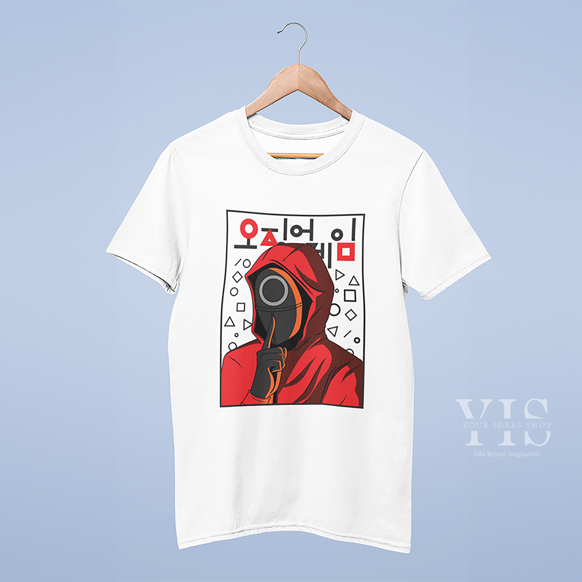 A mockup of a white T-shirt hanging on a wooden hanger, featuring a red-hooded Squid Game character with a circle mask, surrounded by geometric shapes and Korean text. Displayed against a light blue background. Made by Your iDeas Shop