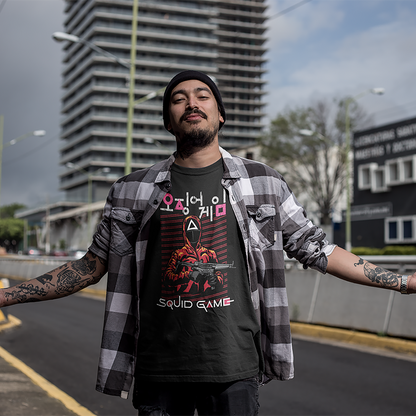 A streetwear-inspired mockup of a man wearing a 'Squid Game' T-shirt, featuring the series' signature masked guard and bold text design, set against a cityscape backdrop. Ideal for urban fashion promotions. Made by Your iDeas Shop.