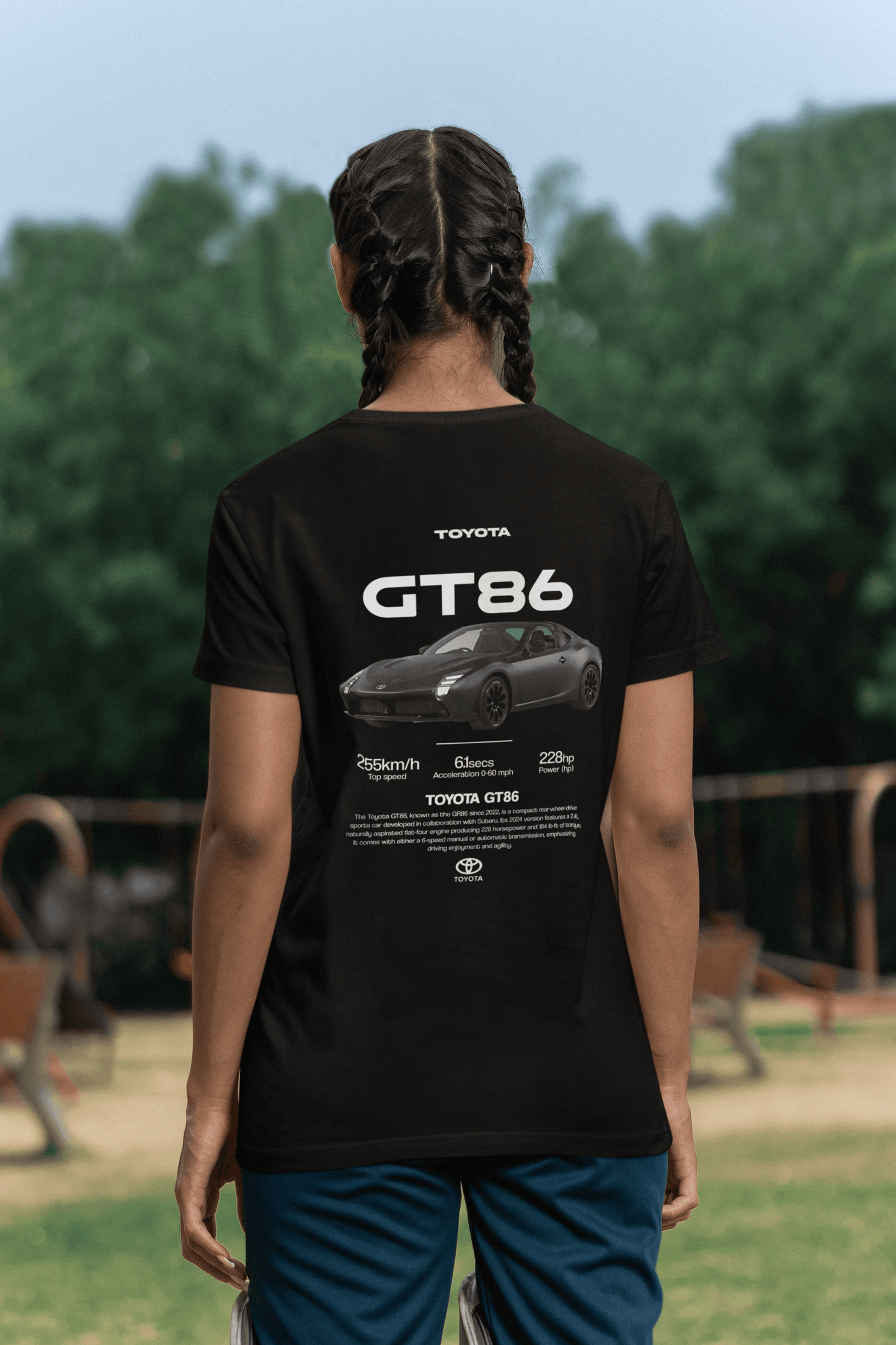 Back view of a person wearing a black Toyota GT86 Sports Car Graphic T-Shirt featuring specs and sleek car design.