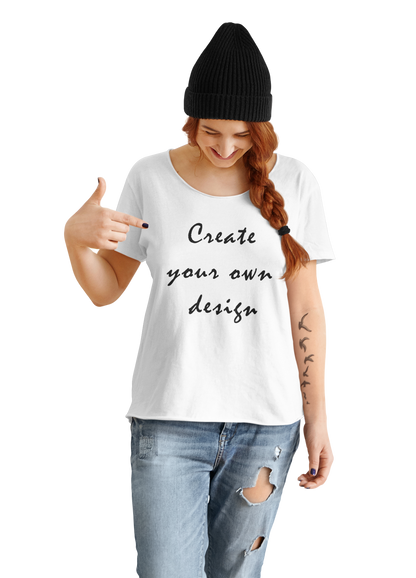A tattooed woman wearing a black beanie and distressed jeans points to her white t-shirt featuring the text "Create your own design." This stylish and creative design is perfect for those looking to express their individuality through fashion.