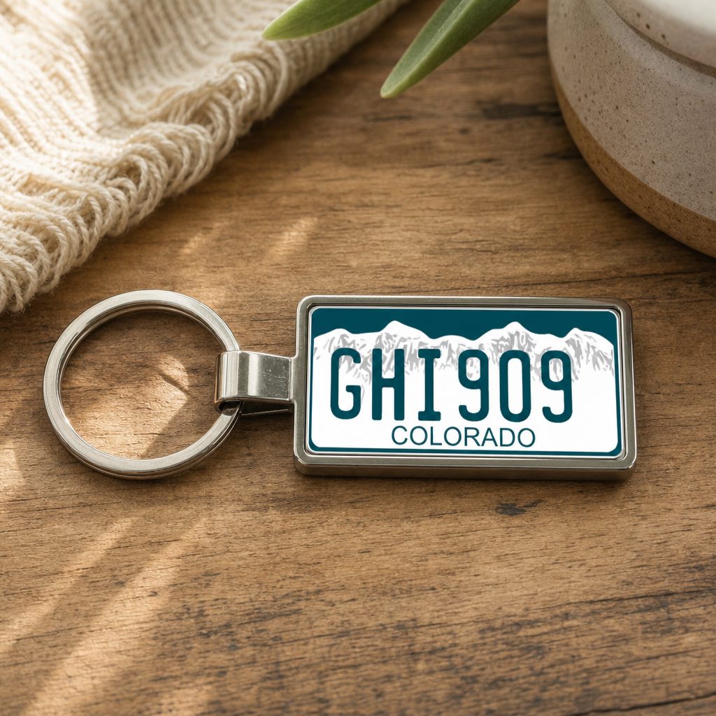 Colorado GHI 909 license plate keychain on_wood