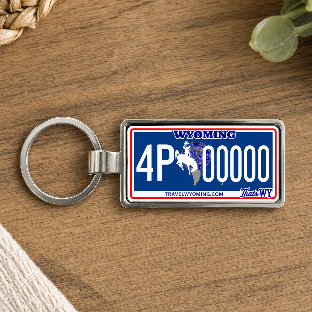 Wyoming license plate keychain on wooden table