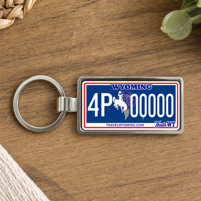 Wyoming license plate keychain on wooden table