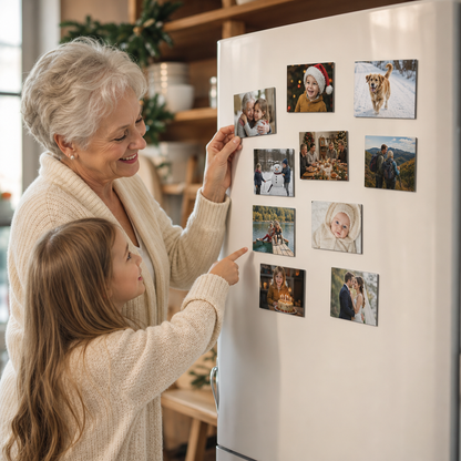 Grandmother and granddaughter putting personalized photo magnets on the fridge