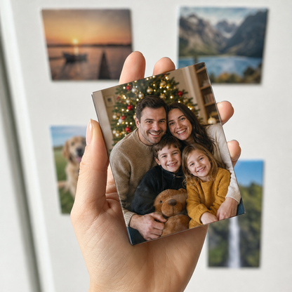Hand holding one 9 x 6 cm custom photo magnet with a family Christmas photo