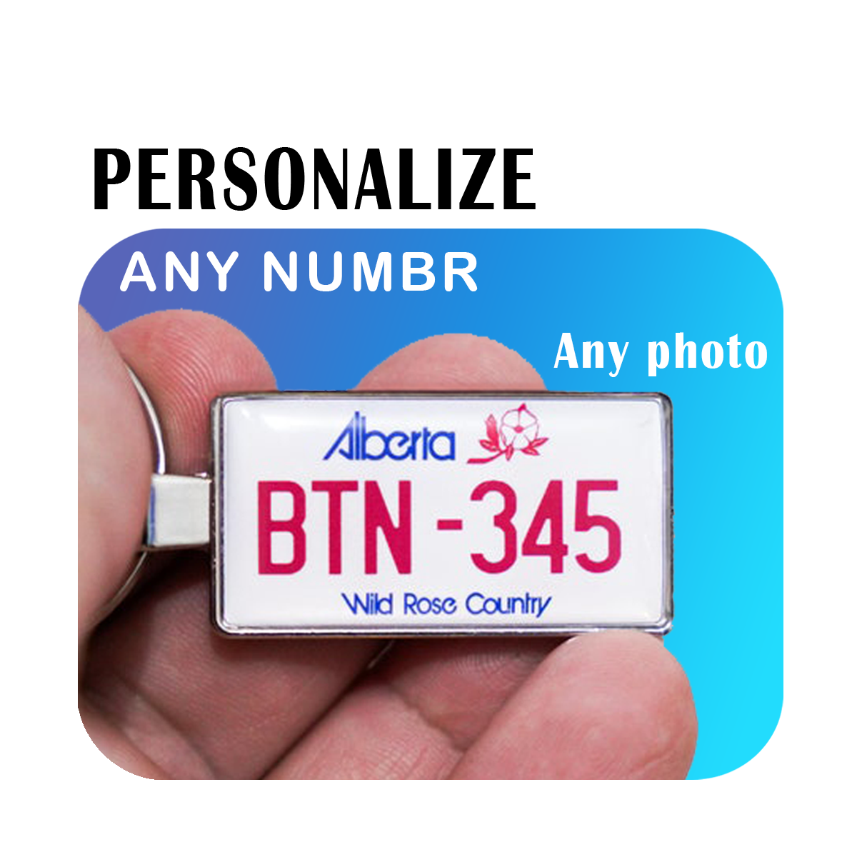 A personalized keychain featuring an Alberta license plate with the text 'BTN-345', held in a hand. The text "PERSONALIZE ANY NUMBER" is written above in bold letters, showcasing the possibility for customization. The background is a gradient from blue to light blue with additional text 'Any photo' indicating versatility. This design represents the identity of Alberta and is perfect for those wanting a personalized touch to represent their love for this Canadian province. Created by Your iDeas Shop.