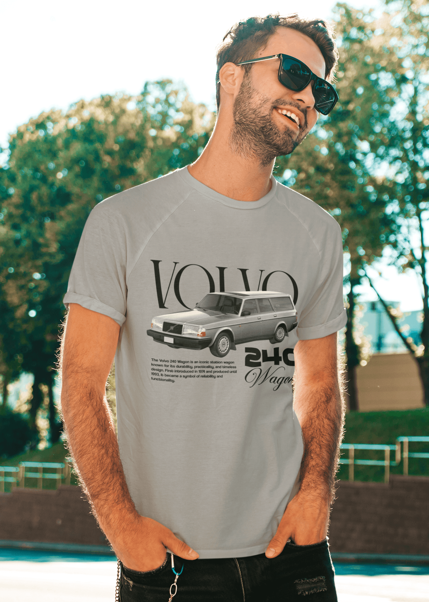 Volvo 240 Wagon Graphic T-Shirt — Classic Swedish Brick worn by a smiling man in sunglasses outdoors.